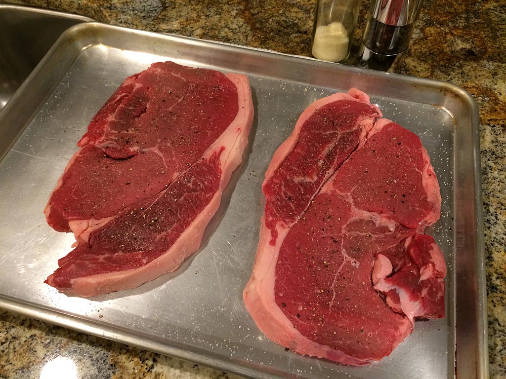 Steaks seasoned with garlic salt and black pepper