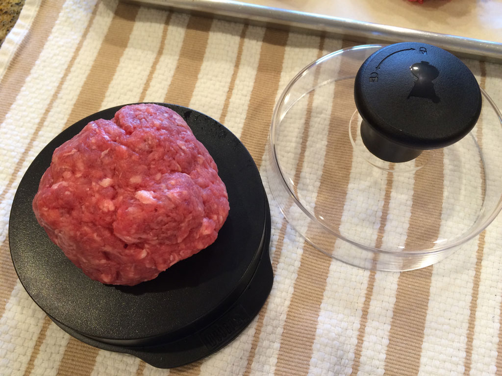 Placing meat into burger press