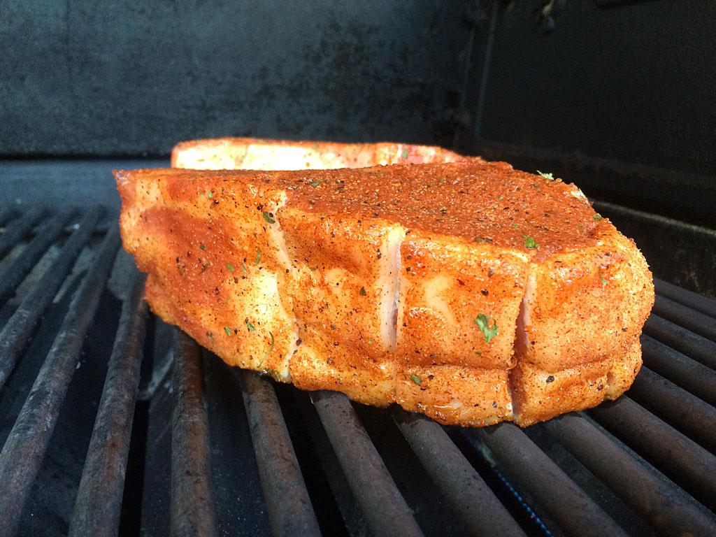 Pork chop goes onto the grill
