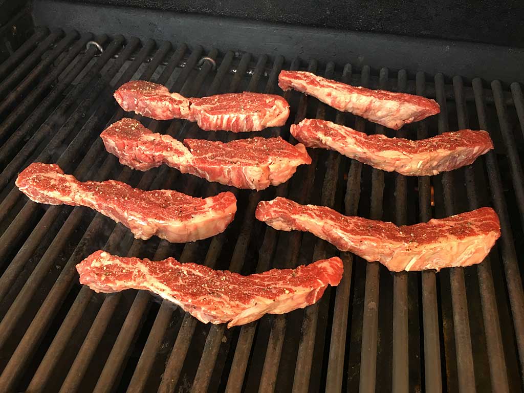 Ribeye cap steaks go onto the grill