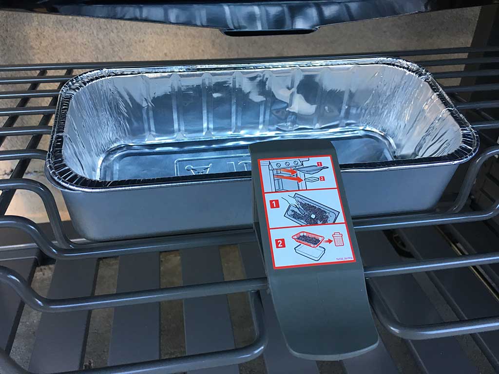 The drip pan has a plastic latch that holds it in place.