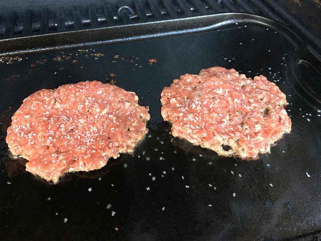 Smashed burgers seasoned with salt and pepper