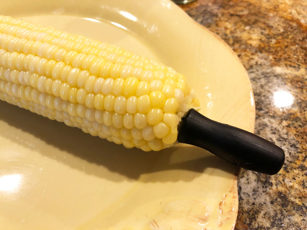 Close-up of corn pick and corn on the cob