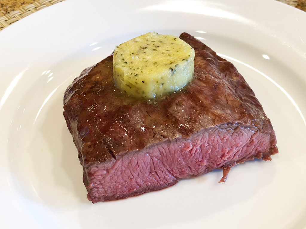 Half of flat iron steak with compound butter
