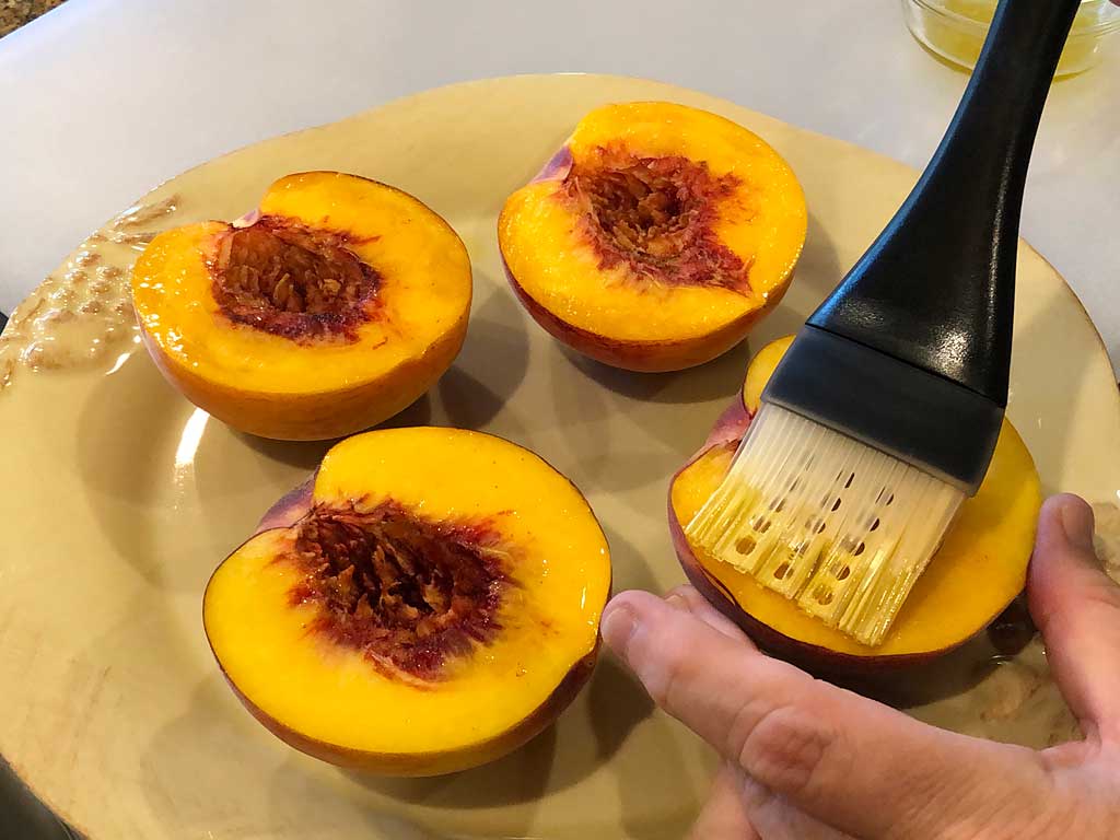 Brushing peaches with olive oil mixture