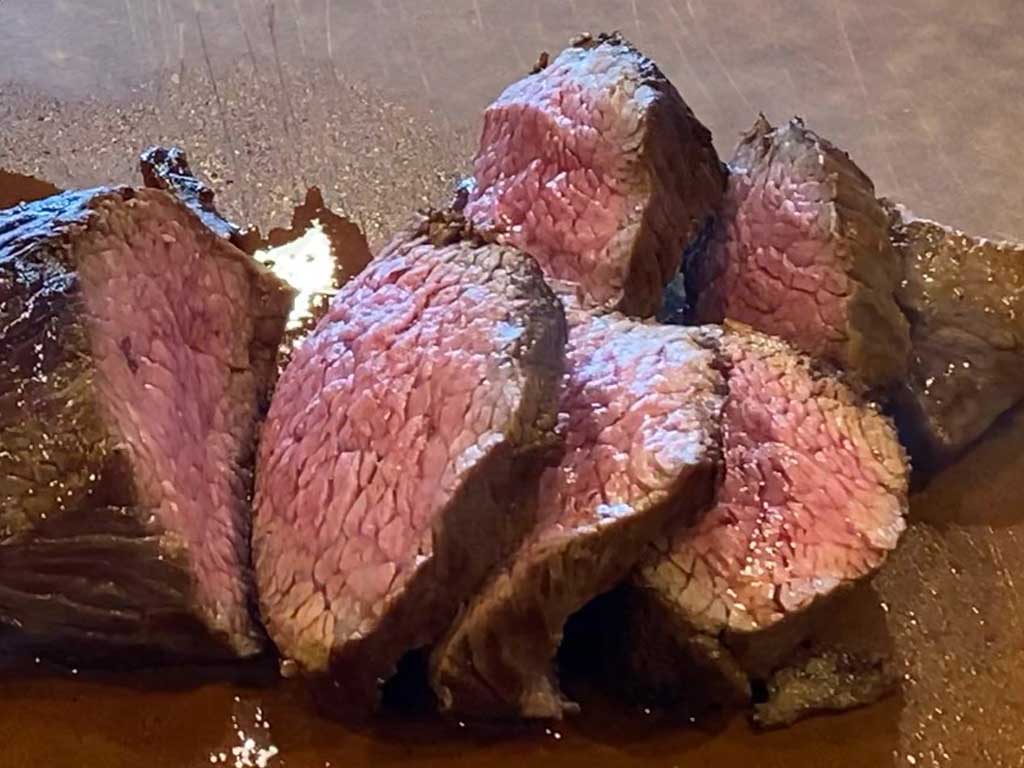 Rested and sliced teres major steak